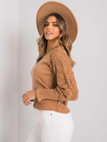 Camel sweater with long twisted sleeves and tightened at the wrists